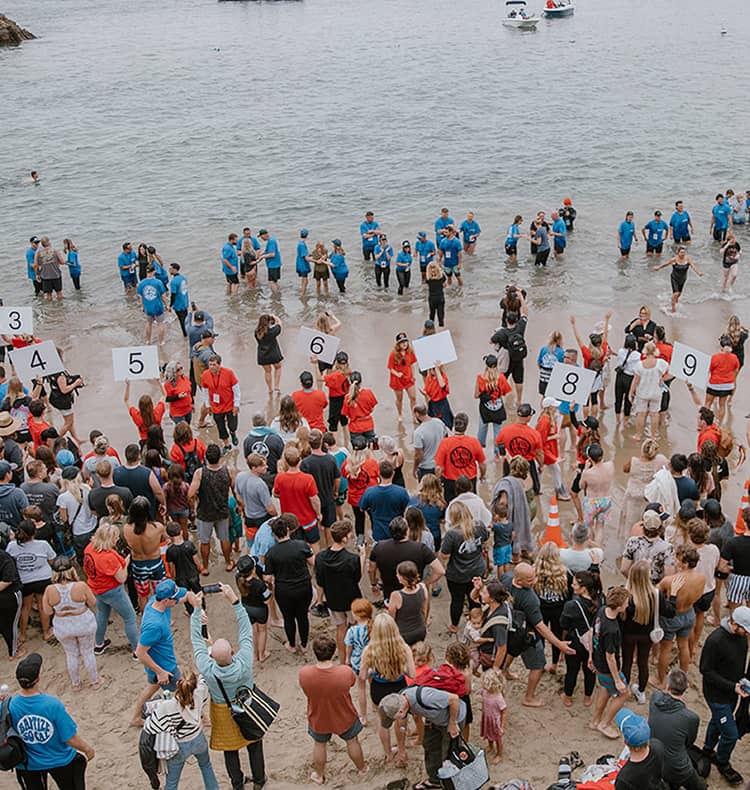 People being baptized at the beach